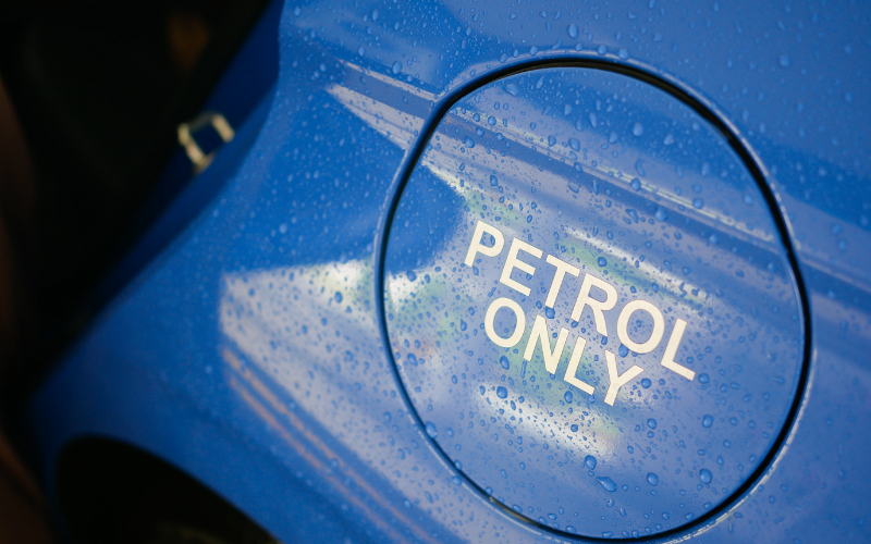 Close-up of a blue vehicle showing petrol fuel tank cap